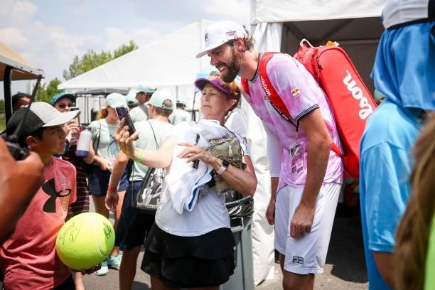 Reilly Opelka takes a photo with a fan following a doubles match with Jannik Sinner in which they beat Jonathan Erlich and Santiago Gonzalez at the...