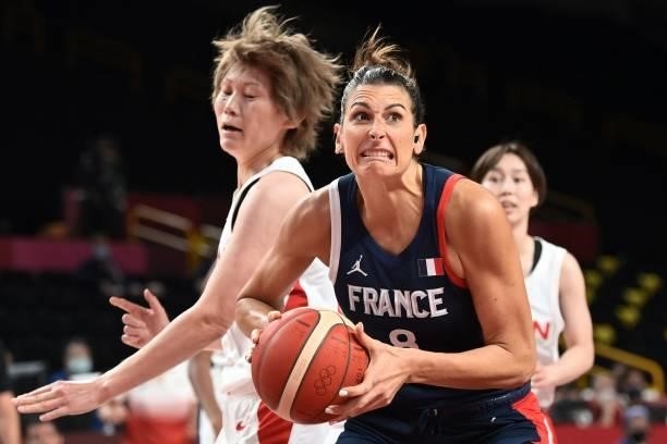 France's Helena Ciak handles the ball in the women's preliminary round group B basketball match between France and Japan during the Tokyo 2020...