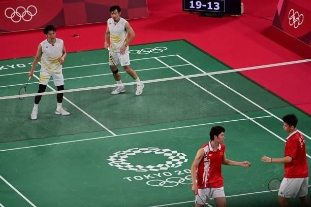 Japan's Keigo Sonoda and Japan's Takeshi Kamura react after a point with China's Liu Yuchen and China's Li Junhui in their men's doubles badminton...