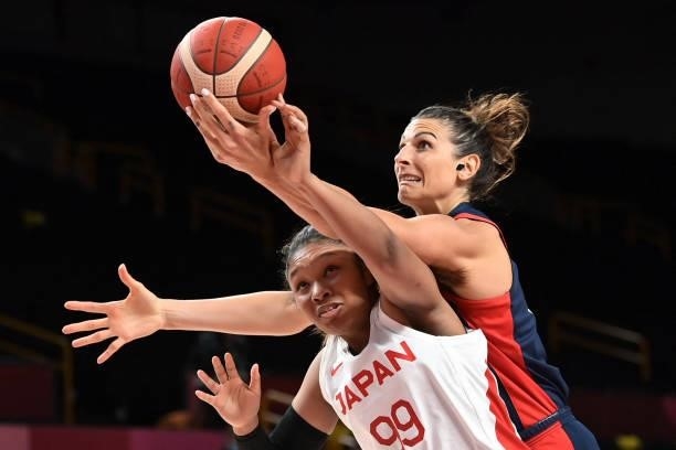 Japan's Monica Okoye fights for the ball with France's Helena Ciak in the women's preliminary round group B basketball match between France and Japan...