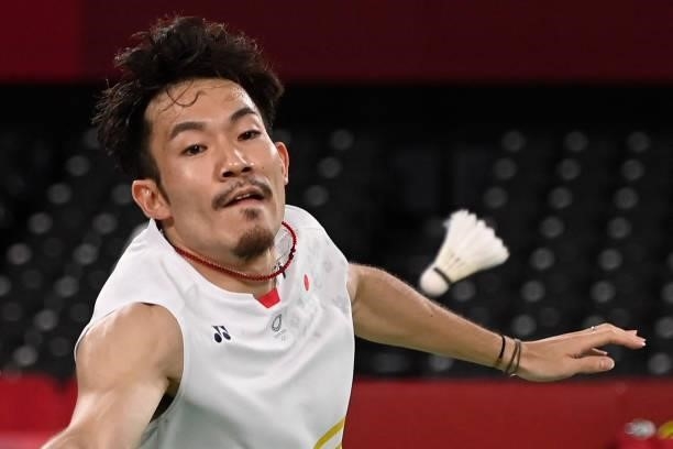 Japan's Keigo Sonoda looks at the shuttlecock in his men's doubles badminton group stage match with Japan's Takeshi Kamura against China's Liu Yuchen...