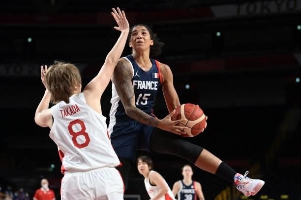 France's Gabrielle Williams goes to the basket as Japan's Maki Takada tries to block in the women's preliminary round group B basketball match...