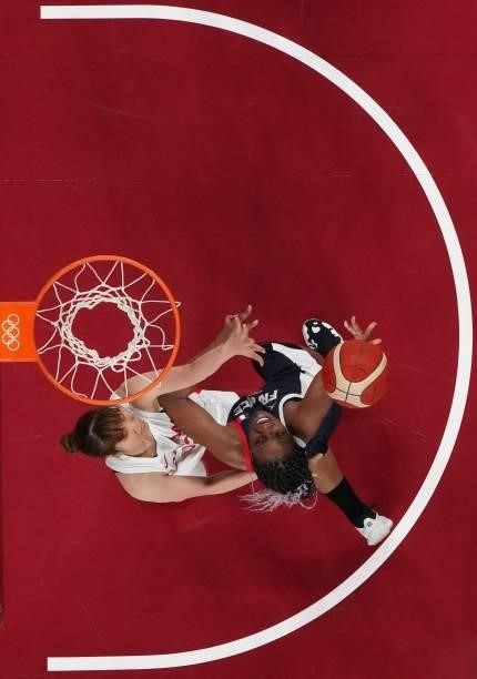 France's Endene Miyem goes to the basket past Japan's Saori Miyazaki in the women's preliminary round group B basketball match between France and...