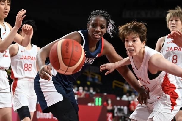 France's Endene Miyem looks at the ball in the women's preliminary round group B basketball match between France and Japan during the Tokyo 2020...