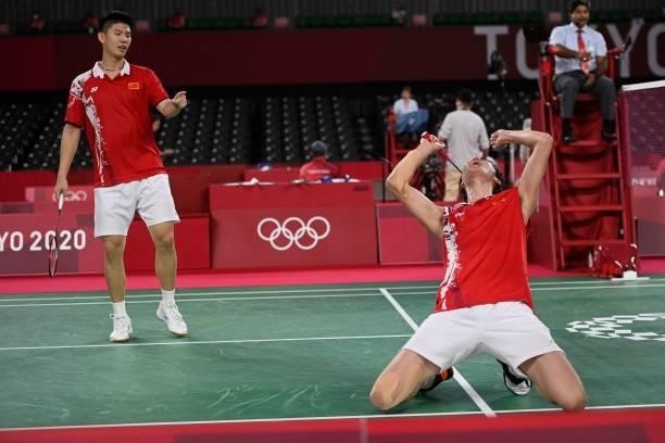 China's Li Junhui reacts after winning with China's Liu Yuchen in their men's doubles badminton group stage match against Japan's Keigo Sonoda and...
