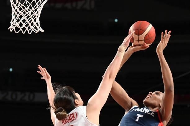 France's Sandrine Gruda shoots the ball as Japan's Moeko Nagaoka tries to block in the women's preliminary round group B basketball match between...