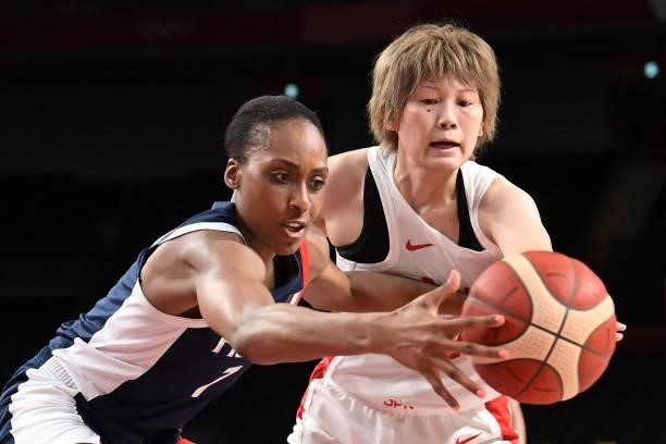Japan's Maki Takada and France's Sandrine Gruda fight for the ball in the women's preliminary round group B basketball match between France and Japan...