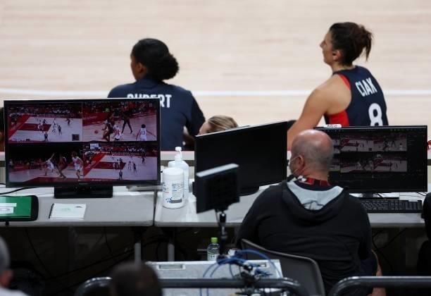 An official follows the play on monitors to assist referees during the women's preliminary round group B basketball match between France and Japan of...