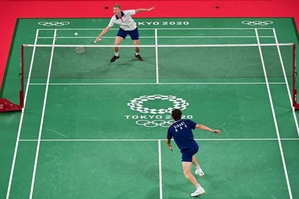 Estonia's Raul Must hits a shot against Spain's Pablo Abian in their men's singles badminton group stage match during the Tokyo 2020 Olympic Games at...