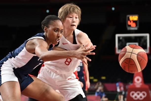 Japan's Maki Takada and France's Sandrine Gruda fight for the ball in the women's preliminary round group B basketball match between France and Japan...