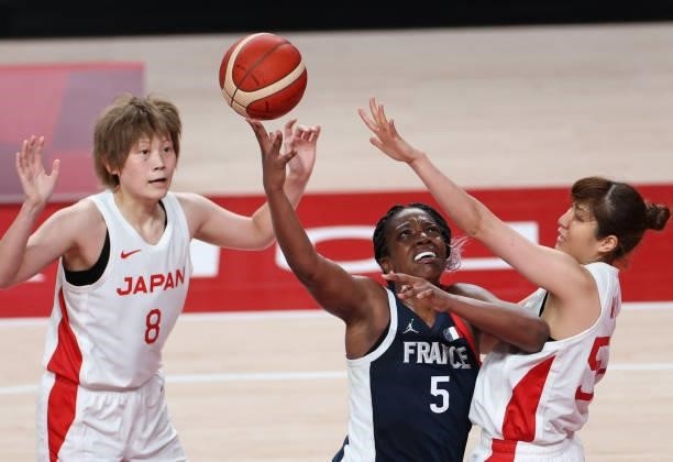 France's Endene Miyem goes to the basket past Japan's Yuki Miyazawa in the women's preliminary round group B basketball match between France and...