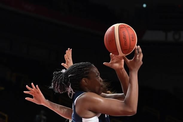 France's Endene Miyem handles the ball in the women's preliminary round group B basketball match between France and Japan during the Tokyo 2020...