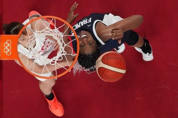 France's Endene Miyem goes to the basket past Japan's Saori Miyazaki in the women's preliminary round group B basketball match between France and...