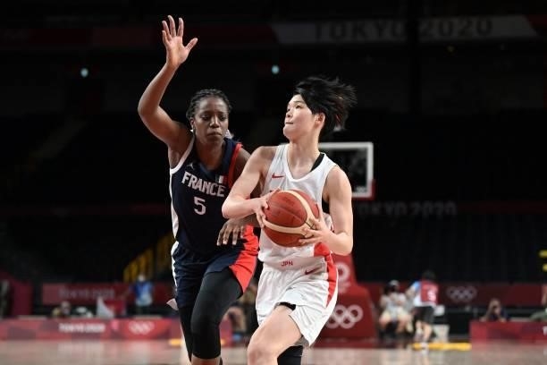 Japan's Himawari Akaho dribbles the ball past France's Endene Miyem in the women's preliminary round group B basketball match between France and...