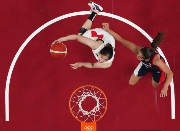 Japan's Moeko Nagaoka goes to the basket past France's Marine Fauthoux in the women's preliminary round group B basketball match between France and...