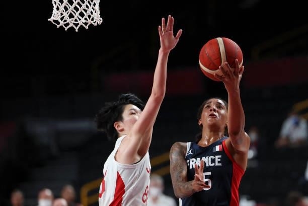 France's Endene Miyem goes to the basket past Japan's Himawari Akaho in the women's preliminary round group B basketball match between France and...