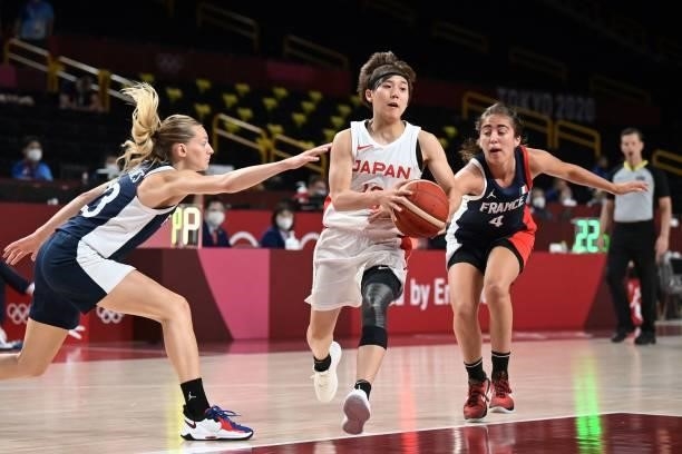 Japan's Rui Machida runs with the ball past France's Marine Fauthoux in the women's preliminary round group B basketball match between France and...
