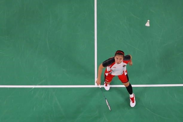 Indonesia's Greysia Polii hits a shot next to Indonesia's Apriyani Rahayu in their women's doubles badminton group stage match against Japan's Sayaka...