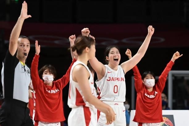 Japanese players celebrate after their win in the women's preliminary round group B basketball match between France and Japan during the Tokyo 2020...