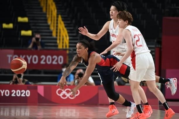 France's Gabrielle Williams passes the ball past Japan's Saki Hayashi and Himawari Akaho in the women's preliminary round group B basketball match...