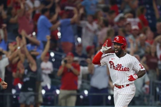 Andrew McCutchen of the Philadelphia Phillies rounds third base after he hit a walk off three-run home run in the ninth inning of a game against the...