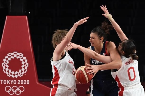 France's Helena Ciak fights for the ball with Japan's Maki Takada and Moeko Nagaoka in the women's preliminary round group B basketball match between...