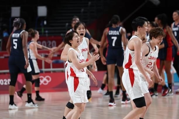 Japan's player celebrate their victory at then end of the women's preliminary round group B basketball match between France and Japan during the...