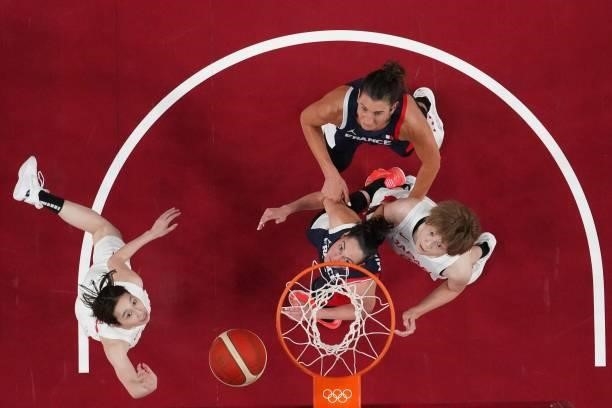 France's Helena Ciak and Sarah Michel go for a rebound with Japan's Maki Takada in the women's preliminary round group B basketball match between...