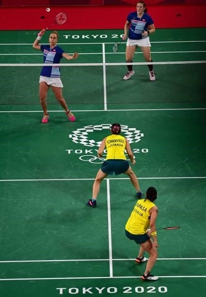 Denmark's Sara Thygesen hits a shot next to Denmark's Maiken Fruergaard in their women's doubles badminton group stage match against Australia's...