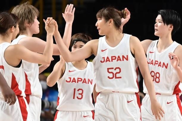 Japanese players celebrate after their win in the women's preliminary round group B basketball match between France and Japan during the Tokyo 2020...