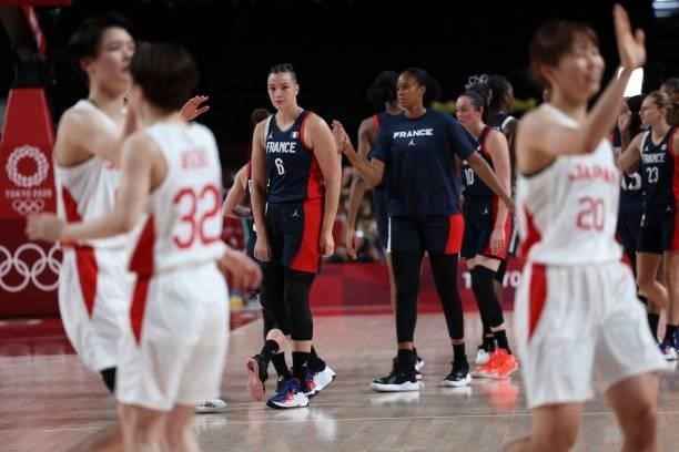 France's Alexia Chartereau looks on as Japan's player celebrate their victory at then end of the women's preliminary round group B basketball match...