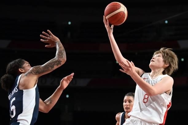 Japan's Maki Takada goes to the basket as France's Gabrielle Williams tries to block in the women's preliminary round group B basketball match...