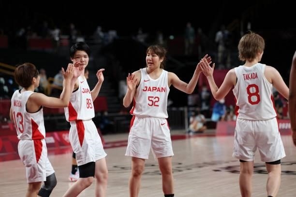 Japan's player celebrate their victory at then end of the women's preliminary round group B basketball match between France and Japan during the...
