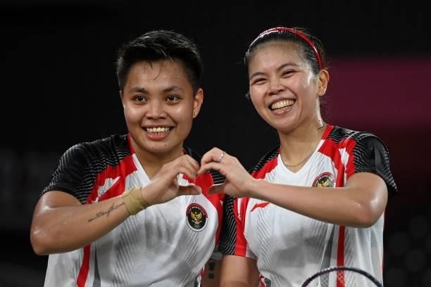 Indonesia's Apriyani Rahayu poses with Indonesia's Greysia Polii after winning their women's doubles badminton group stage match against Japan's...