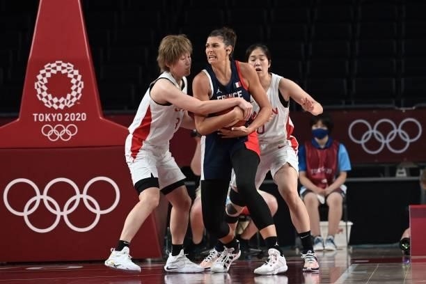 France's Helena Ciak fights for the ball with Japan's Maki Takada and Moeko Nagaoka in the women's preliminary round group B basketball match between...