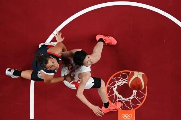 France's Helena Ciak and Japan's Himawari Akaho look at the basket in the women's preliminary round group B basketball match between France and Japan...