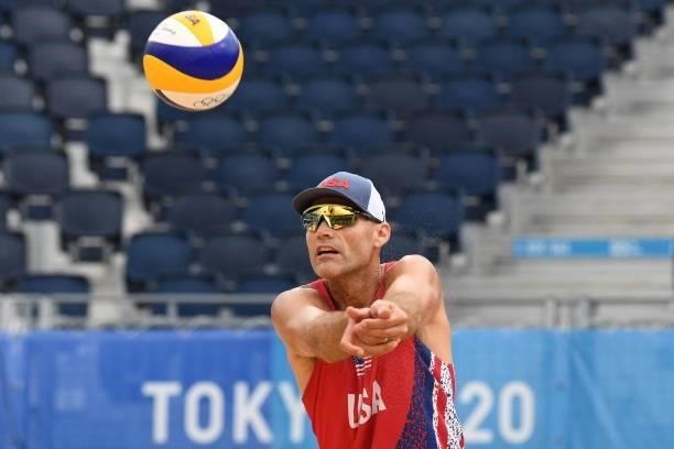S Philip Dalhausser sets the ball in their men's preliminary beach volleyball pool D match between Brazil and the USA during the Tokyo 2020 Olympic...