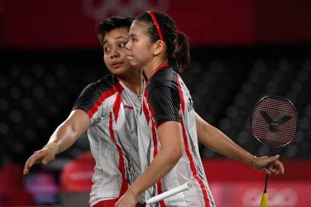 Indonesia's Apriyani Rahayu hugs Indonesia's Greysia Polii after winning their women's doubles badminton group stage match against Japan's Sayaka...