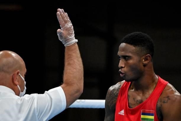 The referee gestures to Mauritius' Merven Clair as he fights Jordan's Zeyad Eishaih Hussein Eashash during their men's welter preliminaries round of...