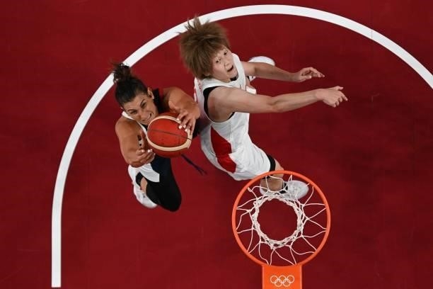 France's Helena Ciak goes to the basket as Japan's Maki Takada watches in the women's preliminary round group B basketball match between France and...