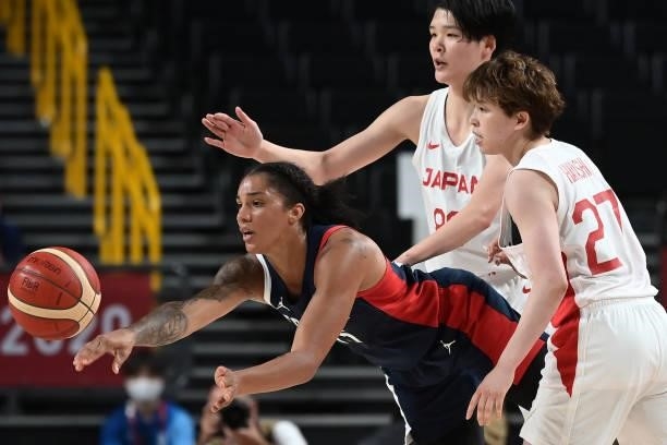 France's Gabrielle Williams passes the ball past Japan's Saki Hayashi and Himawari Akaho in the women's preliminary round group B basketball match...