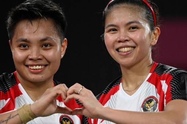 Indonesia's Apriyani Rahayu poses with Indonesia's Greysia Polii after winning their women's doubles badminton group stage match against Japan's...