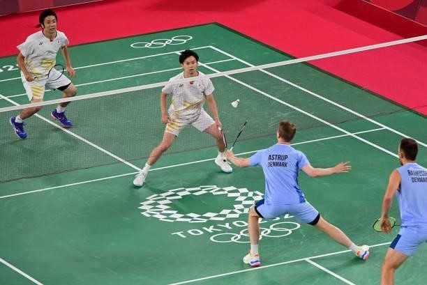 Japan's Yuta Watanabe looks on next to Japan's Hiroyuki Endo in their men's doubles badminton group stage match against Denmark's Kim Astrup and...