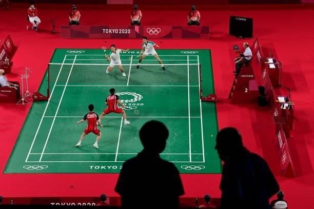 Members of the media are pictured in the arena as Indonesia's Marcus Fernaldi Gideon and Indonesia's Kevin Sanjaya Sukamuljo play in their men's...