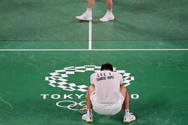 Taiwan's Lee Yang reacts between points in his men's doubles badminton group stage match with Taiwan's Wang Chi-lin against Indonesia's Marcus...