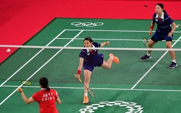 China's Jia Yifan hits a shot next to China's Chen Qingchen in their women's doubles badminton group stage match against South Korea's Kong Hee-yong...