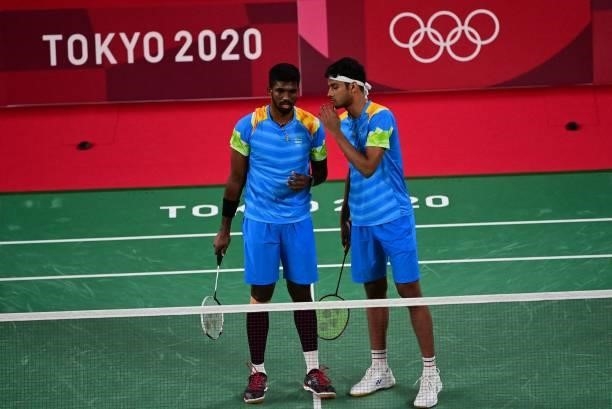 India's Chirag Shetty and India's Satwiksairaj Rankireddy speak during their men's doubles badminton group stage match against Britain's Sean Vendy...