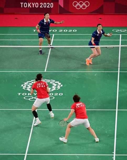 South Korea's Kim So-yeong hits a shot next to South Korea's Kong Hee-yong in their women's doubles badminton group stage match against China's Jia...