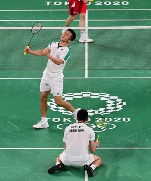 Taiwan's Wang Chi-lin and Taiwan's Lee Yang react after winning their men's doubles badminton group stage match against Indonesia's Marcus Fernaldi...