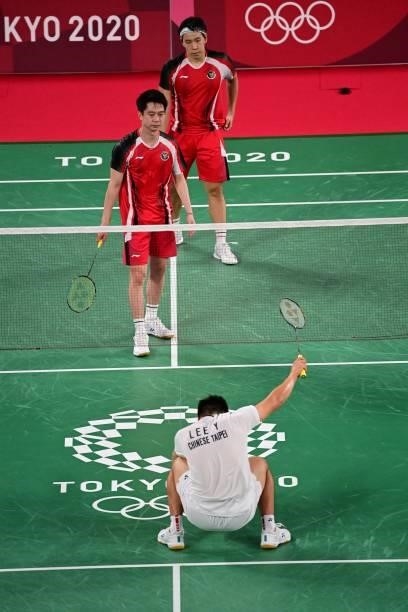 Taiwan's Lee Yang reacts between points in his men's doubles badminton group stage match with Taiwan's Wang Chi-lin against Indonesia's Marcus...